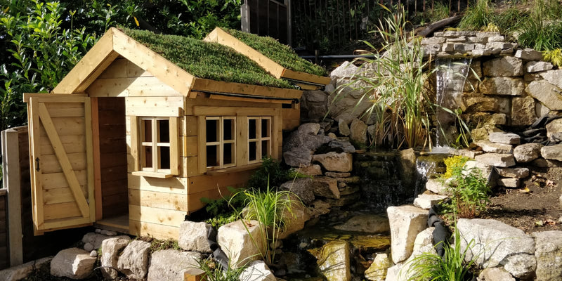 Remove on a children's playhouse with a  rocky and waterfall